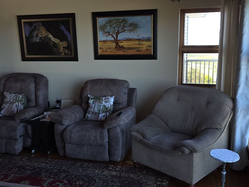 A comfortable living room featuring hardwood flooring and a sliding glass door that provides access to an outdoor balcony area.