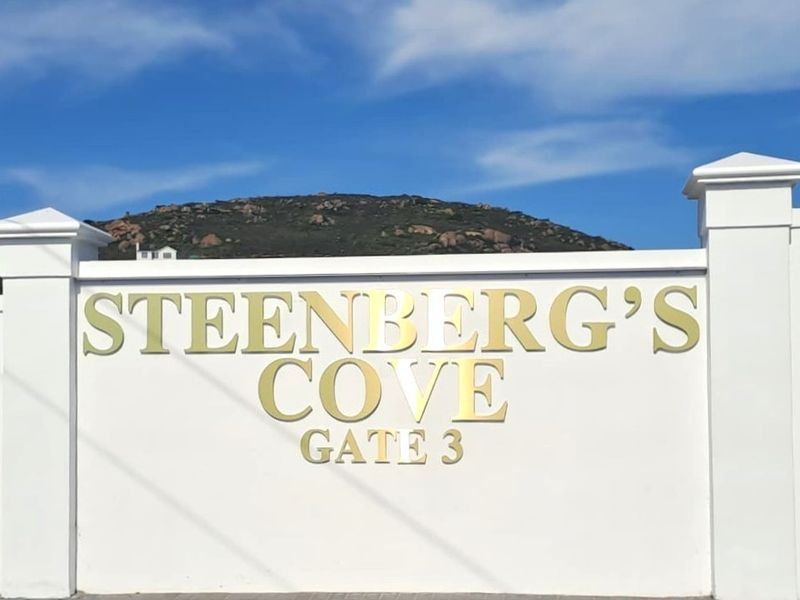 Entrance signage for Steenberg's Cove Gate 3, featuring a clean white boundary wall and clear estate branding.