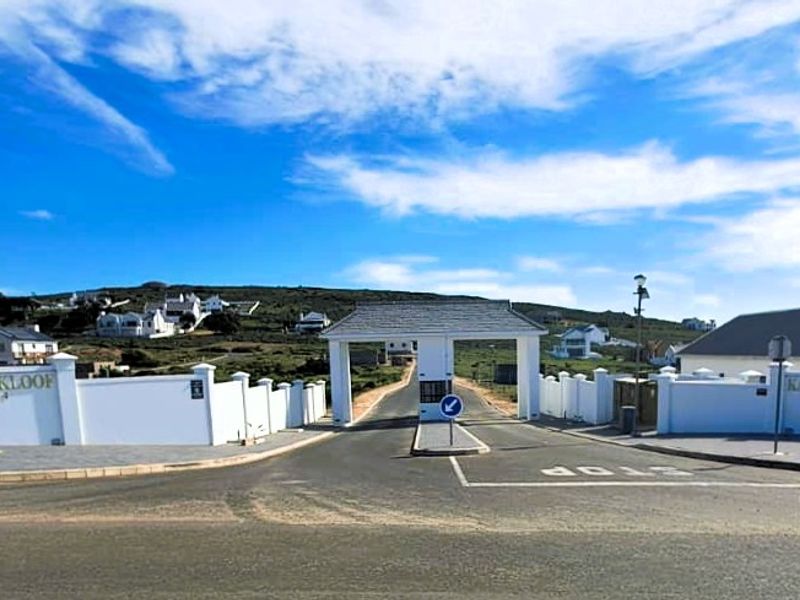 The main entrance gate to the Kapteinskloof residential estate, featuring a secure access point, perimeter walls, and paved driveway.