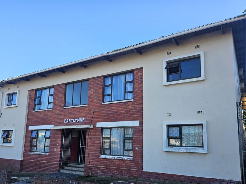 Front elevation of the Eastlynne apartment building featuring a combination of brick and painted plaster finishes with aluminium window frames.