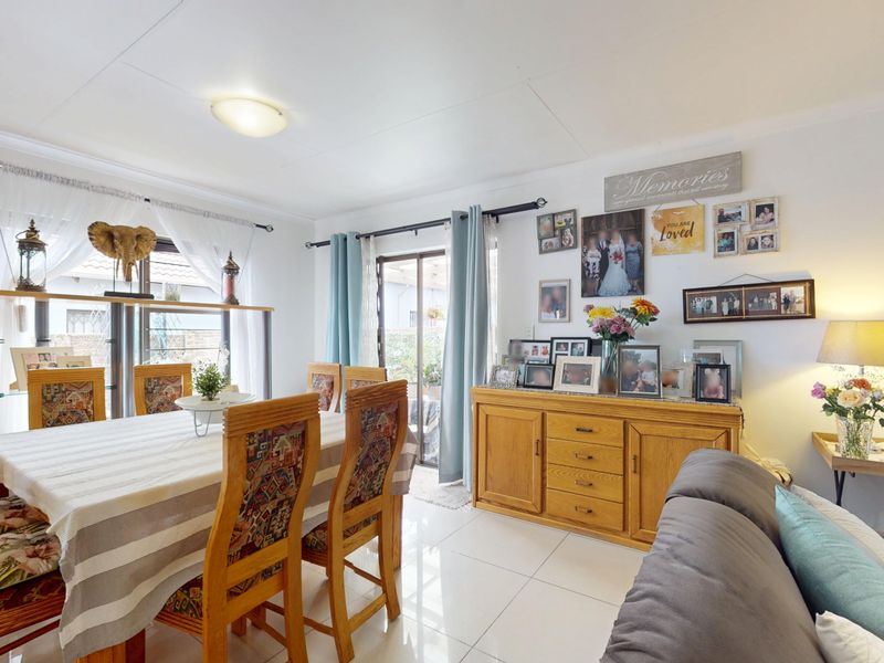 Open plan living and dining area featuring tiled flooring and a sliding glass door providing access to the outdoor space.