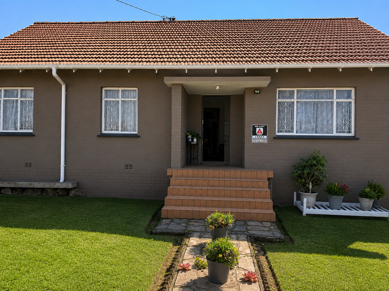 Front elevation of a single-story brick house featuring a tiled roof, central entrance with tiled steps, and well-maintained garden area.