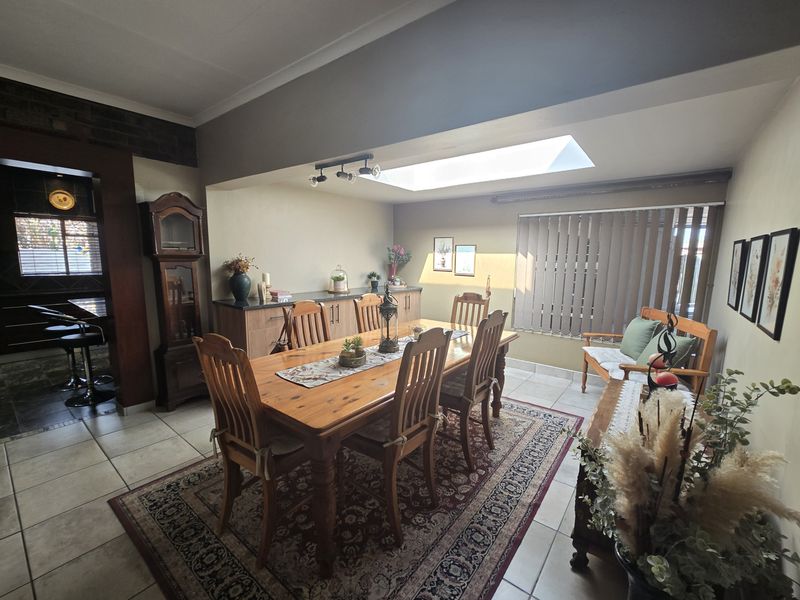 Dining room featuring tiled flooring, built-in cabinetry, and a skylight providing natural light.