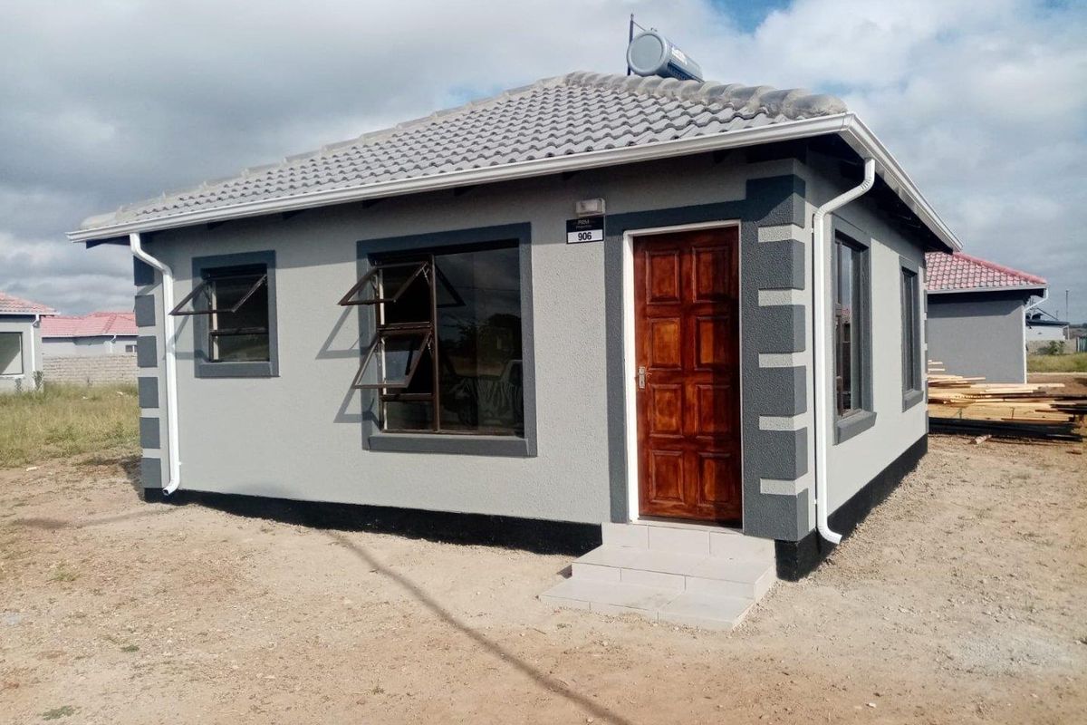 A modern, well-maintained single-story house featuring a tiled roof, solar geyser, and clean exterior finishes with aluminium window frames.