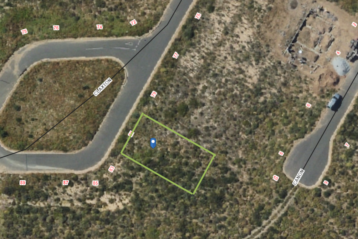 An aerial view of a vacant residential land plot situated between Claxton and Canon streets, showing surrounding road infrastructure and natural vegetation.