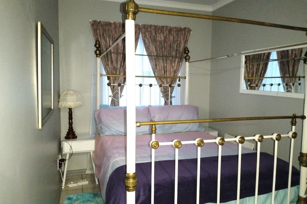 A bedroom featuring tiled flooring and coved ceiling details, providing a functional space for rest.