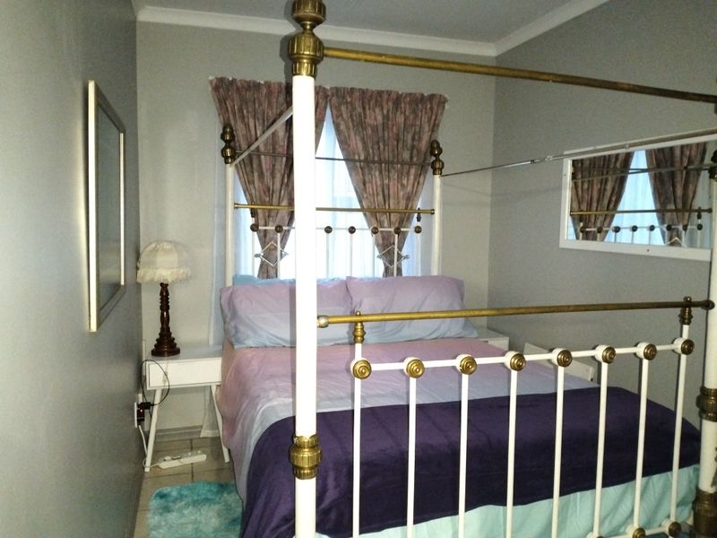 A bedroom featuring tiled flooring and coved ceiling details, providing a functional space for rest.