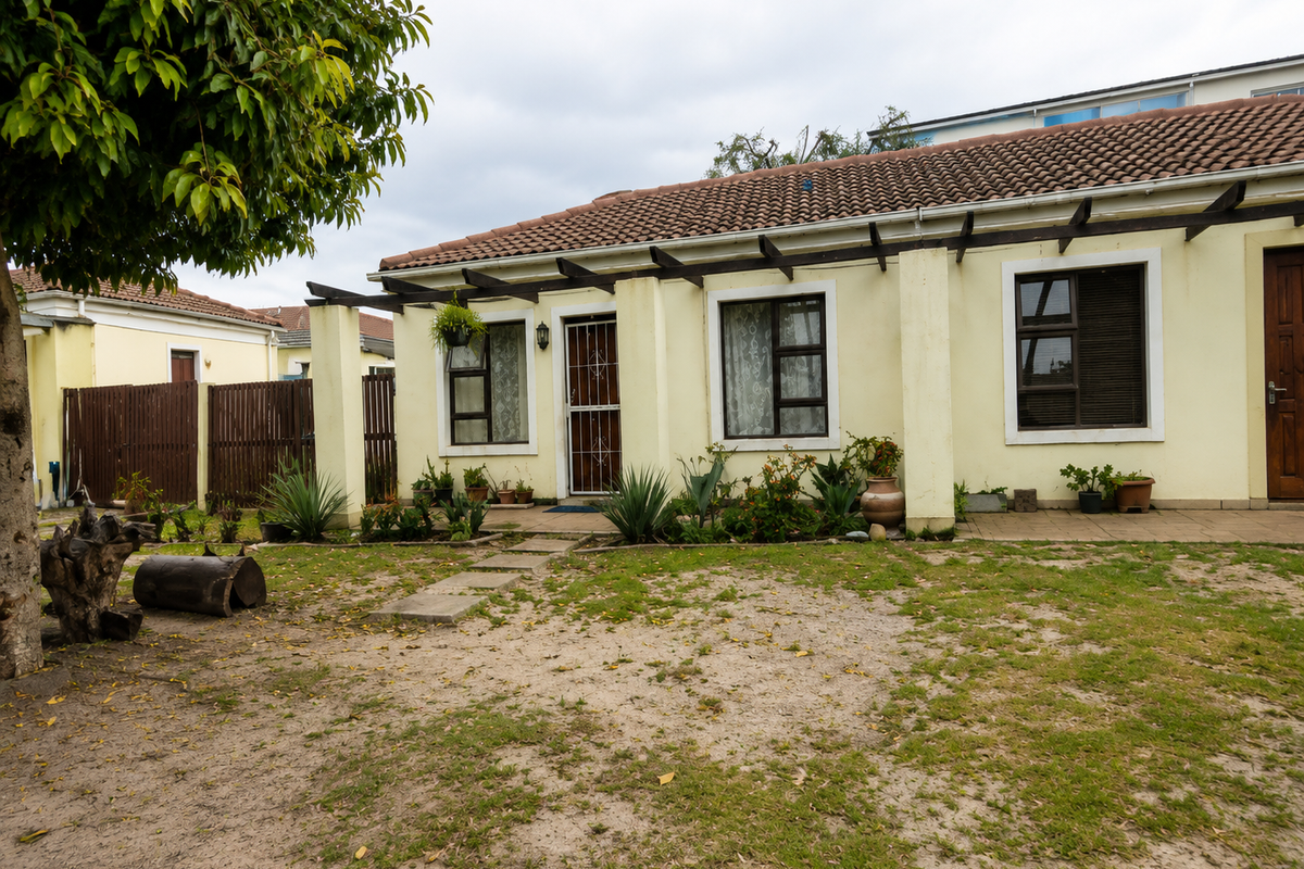 Rear view of the house featuring a paved patio area, timber pergola, and established garden space with a tiled roof.