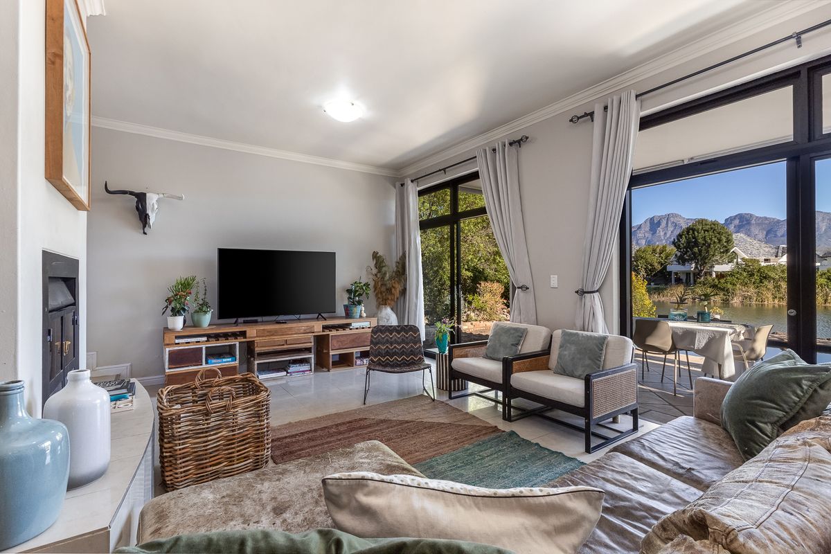 Spacious living room featuring a fireplace, tiled flooring, and large sliding glass doors that provide natural light and access to the outdoor patio area.