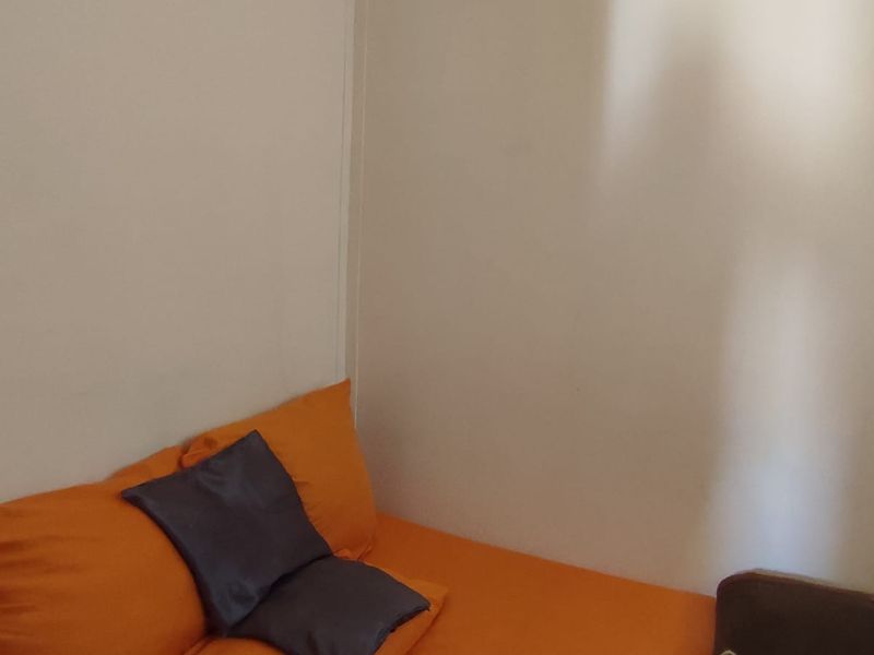 A simple bedroom space with plain walls, suitable for personalization and interior design updates.