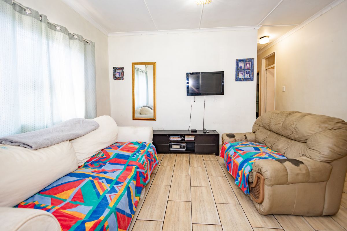 A living room featuring tiled flooring and standard ceiling finishes, providing a functional space for relaxation.