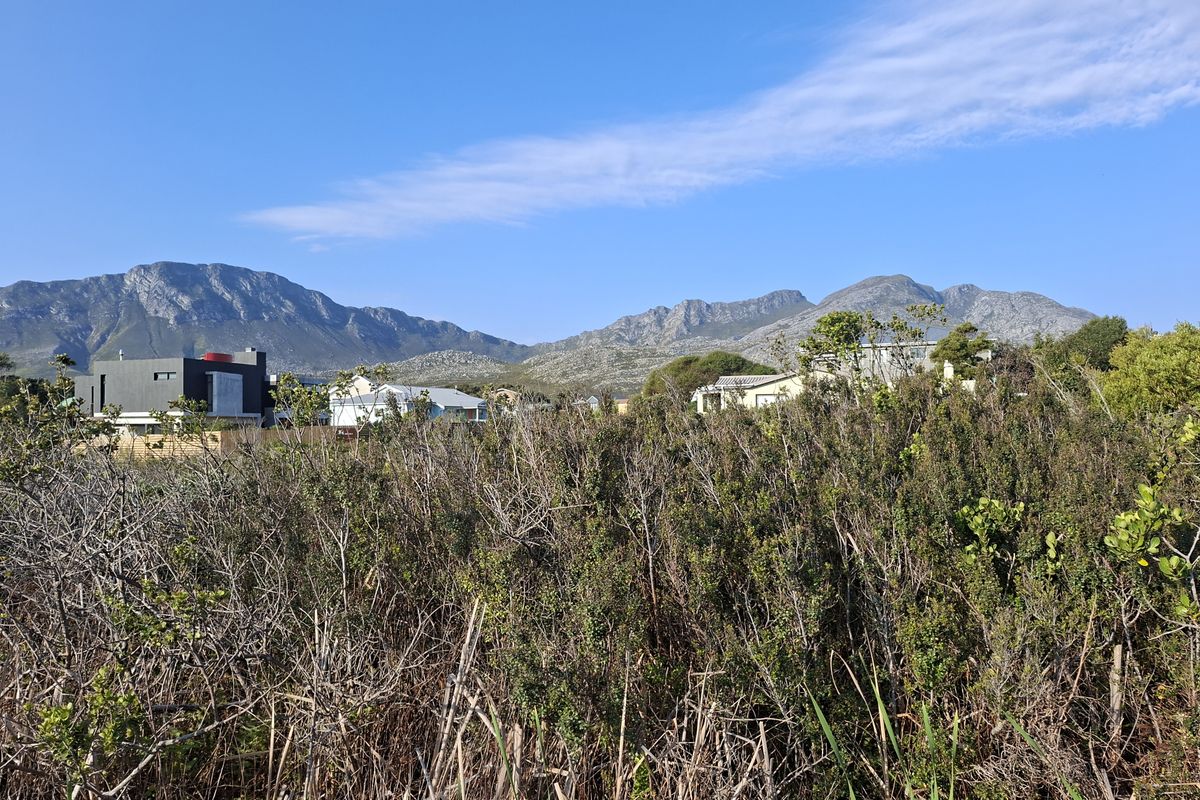 A scenic view of the surrounding landscape and mountain range from the vacant residential property.