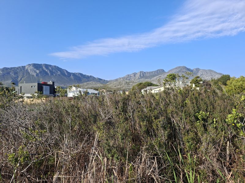A scenic view of the surrounding landscape and mountain range from the vacant residential property.