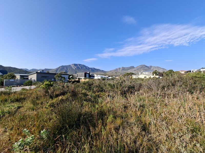 A scenic view of the surrounding landscape and mountain range from the vacant residential plot.