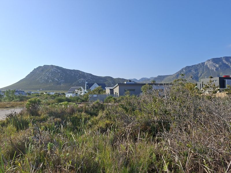 A scenic view of the surrounding landscape featuring natural vegetation and distant mountain ranges, showcasing the property's natural setting.