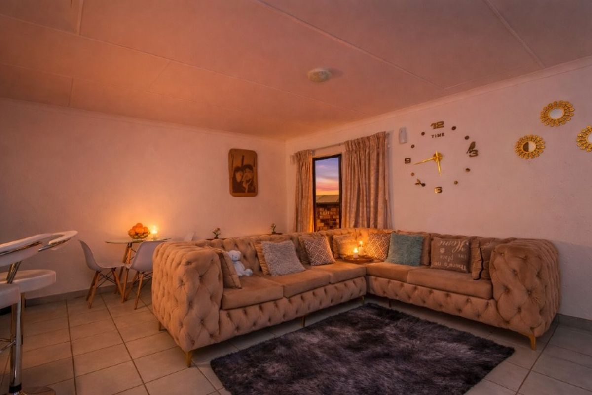 A cozy living room featuring tiled flooring and neutral walls, providing a comfortable and functional space for relaxation.