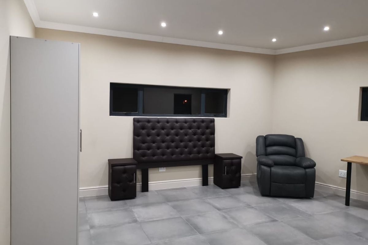 A bedroom featuring neutral walls, tiled flooring, recessed downlighting, and a horizontal window, providing a clean and modern foundation for personalization.