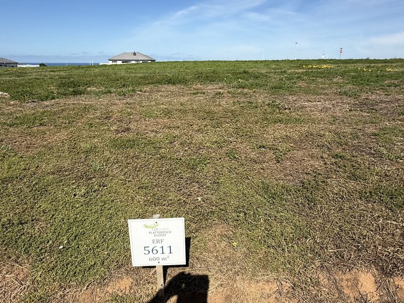 A vacant residential plot of land measuring 600 square meters, situated in a developed estate with surrounding residential properties.