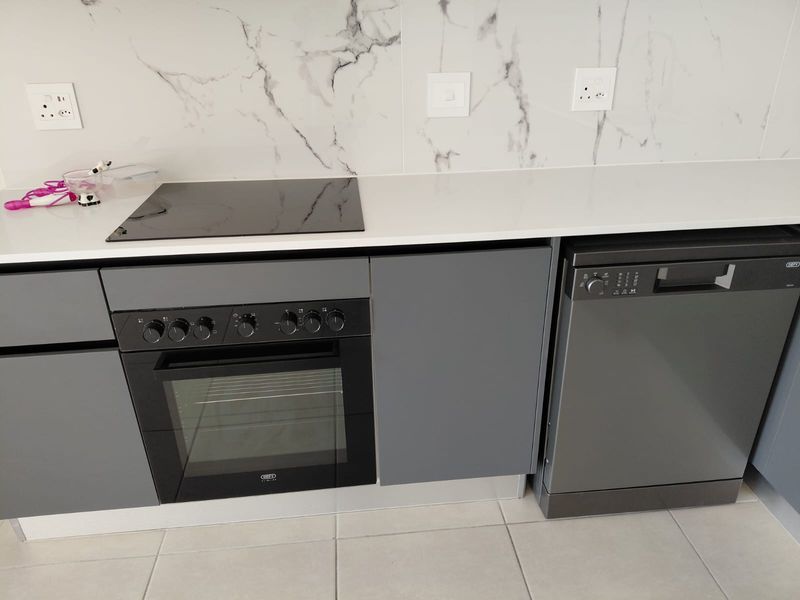 Modern kitchen featuring grey cabinetry, quartz countertops, marble-look splashback, built-in oven, electric hob, and a dishwasher.