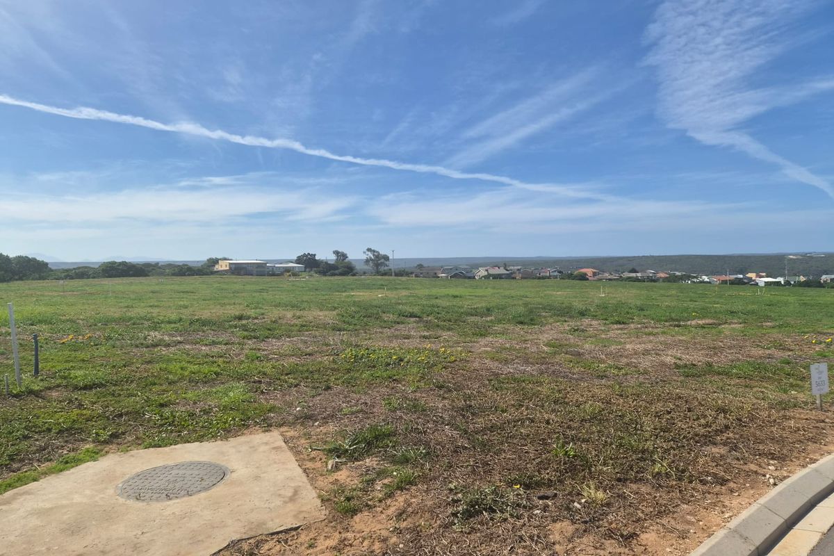 A vacant residential plot featuring level terrain, established curb infrastructure, and clear views of the surrounding neighborhood.