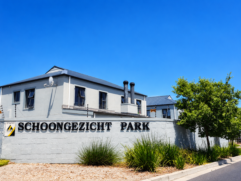 Front view of the Schoongezicht Park townhouse complex, featuring a secure boundary wall, electric fencing, and well-maintained exterior building finishes.