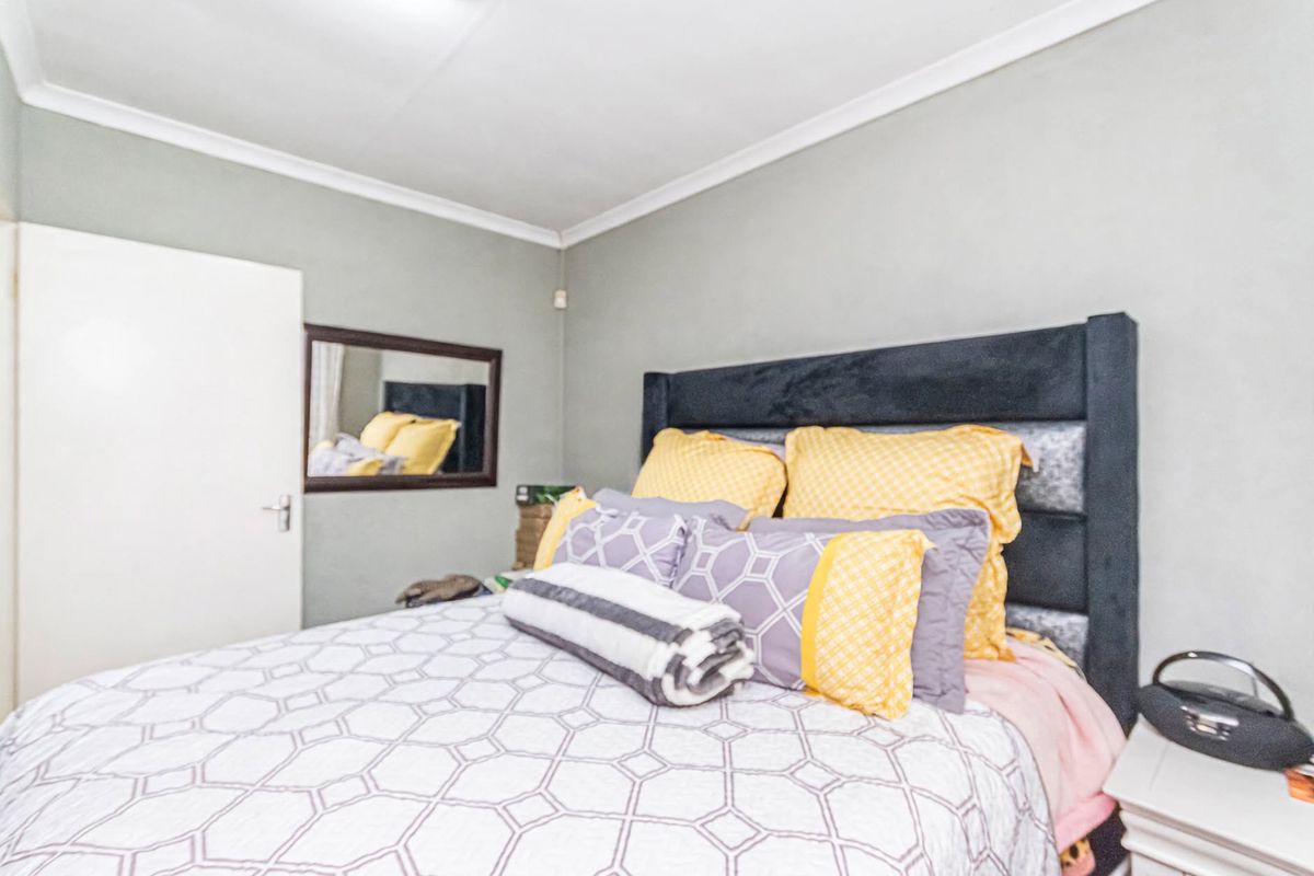 A standard bedroom featuring neutral wall paint, cove cornicing, and a functional internal door.