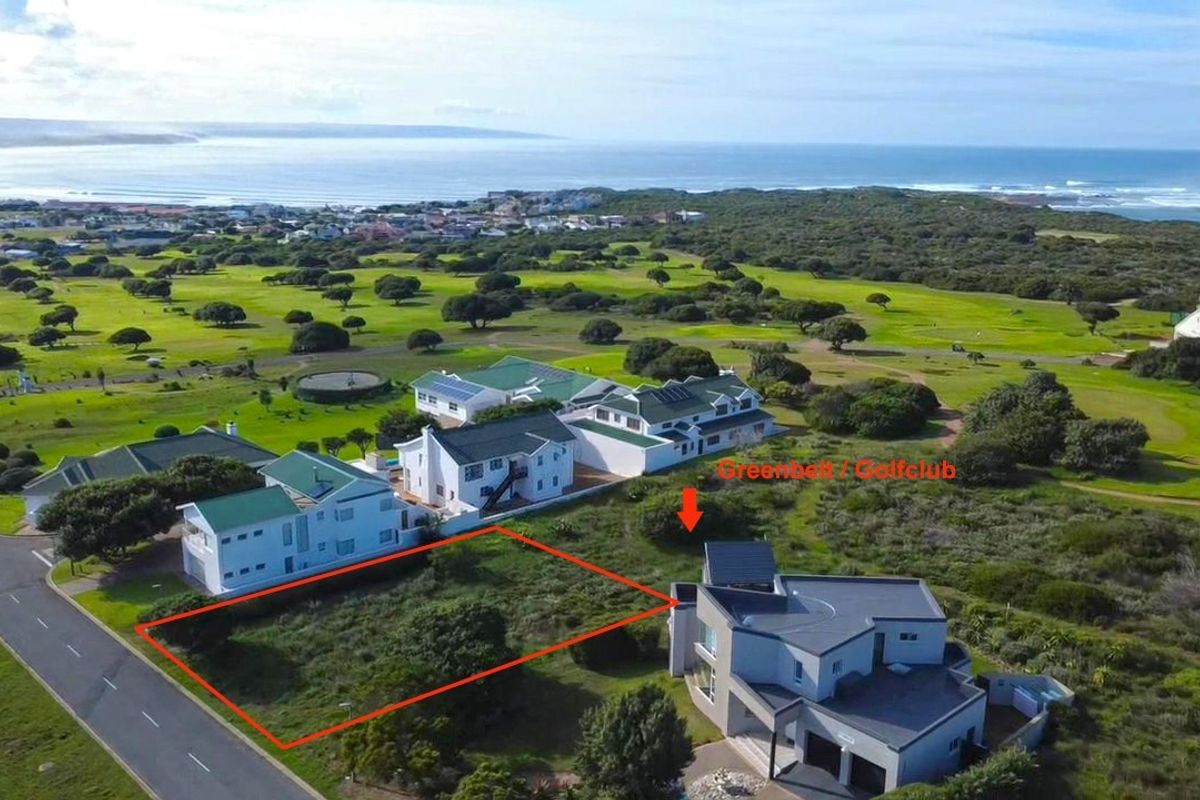 Aerial view of a vacant residential plot situated in a coastal estate, adjacent to a golf course and greenbelt area.