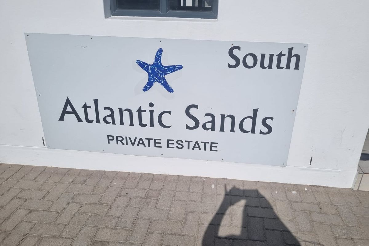 A clear view of the Atlantic Sands Private Estate signage mounted on a wall.