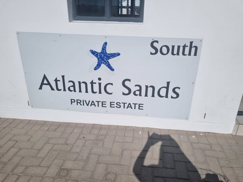 A clear view of the Atlantic Sands Private Estate signage mounted on a wall.