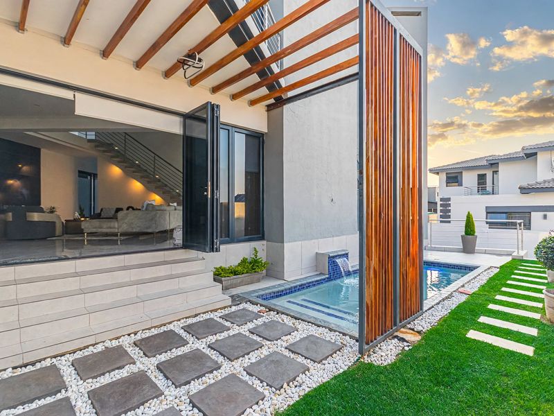 Modern outdoor patio area featuring a timber pergola, a compact plunge pool with a water feature, and seamless access to the interior living space.