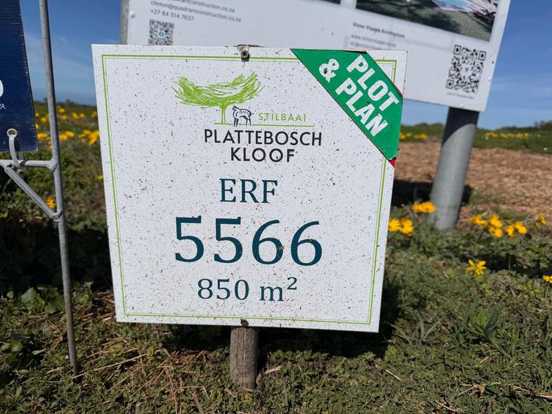 A real estate signage board indicating a vacant residential plot of 850 square meters in Plattebosch Kloof, Stilbaai.