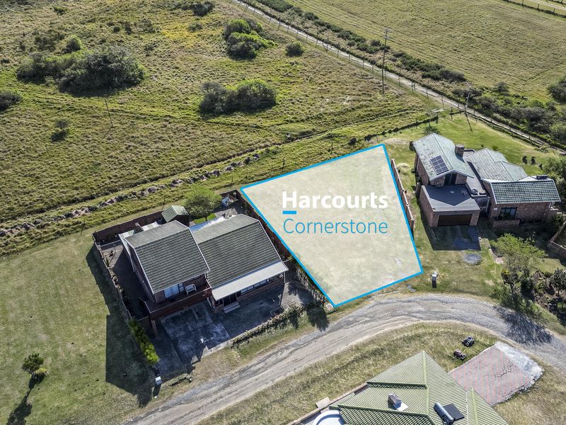 An aerial view of a vacant residential plot situated within a developed estate, highlighting the available land area and surrounding neighborhood context.