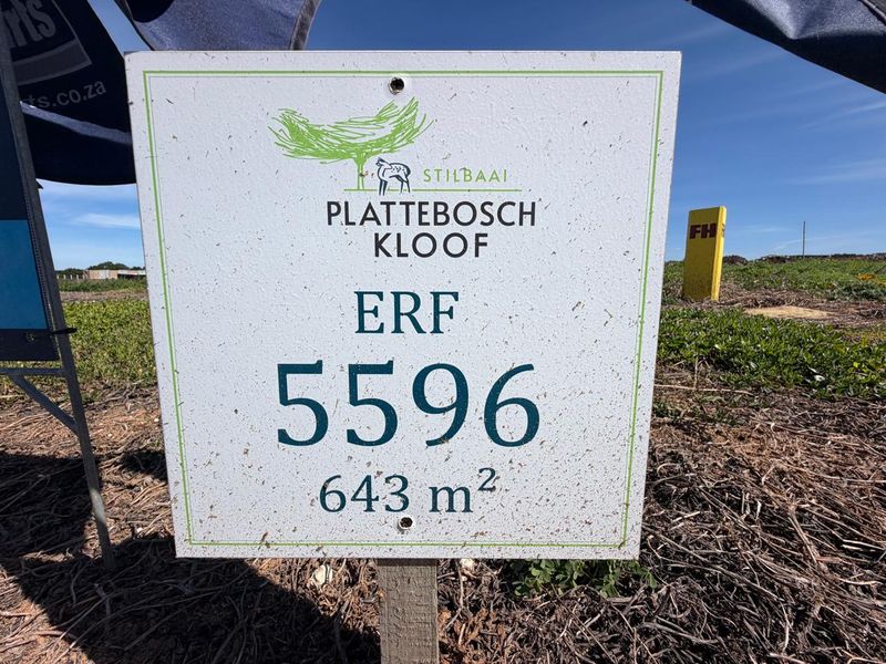 A clear view of the property signage for Erf 5596 in Plattebosch Kloof, Stilbaai, indicating a 643 square meter residential vacant land plot.