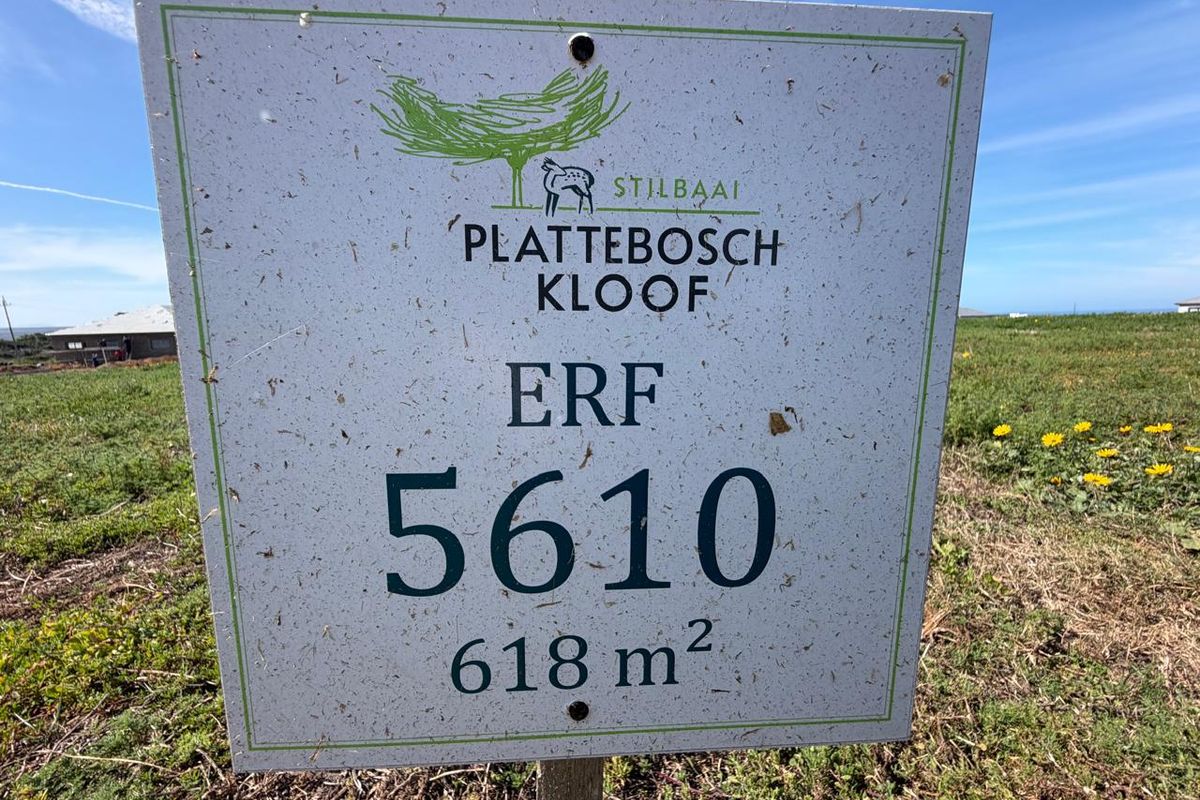 A clear signage board identifying Erf 5610 in Plattebosch Kloof, Stilbaai, indicating a residential land plot of 618 square meters.