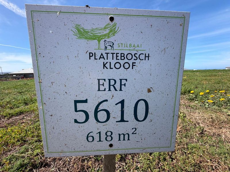 A clear signage board identifying Erf 5610 in Plattebosch Kloof, Stilbaai, indicating a residential land plot of 618 square meters.