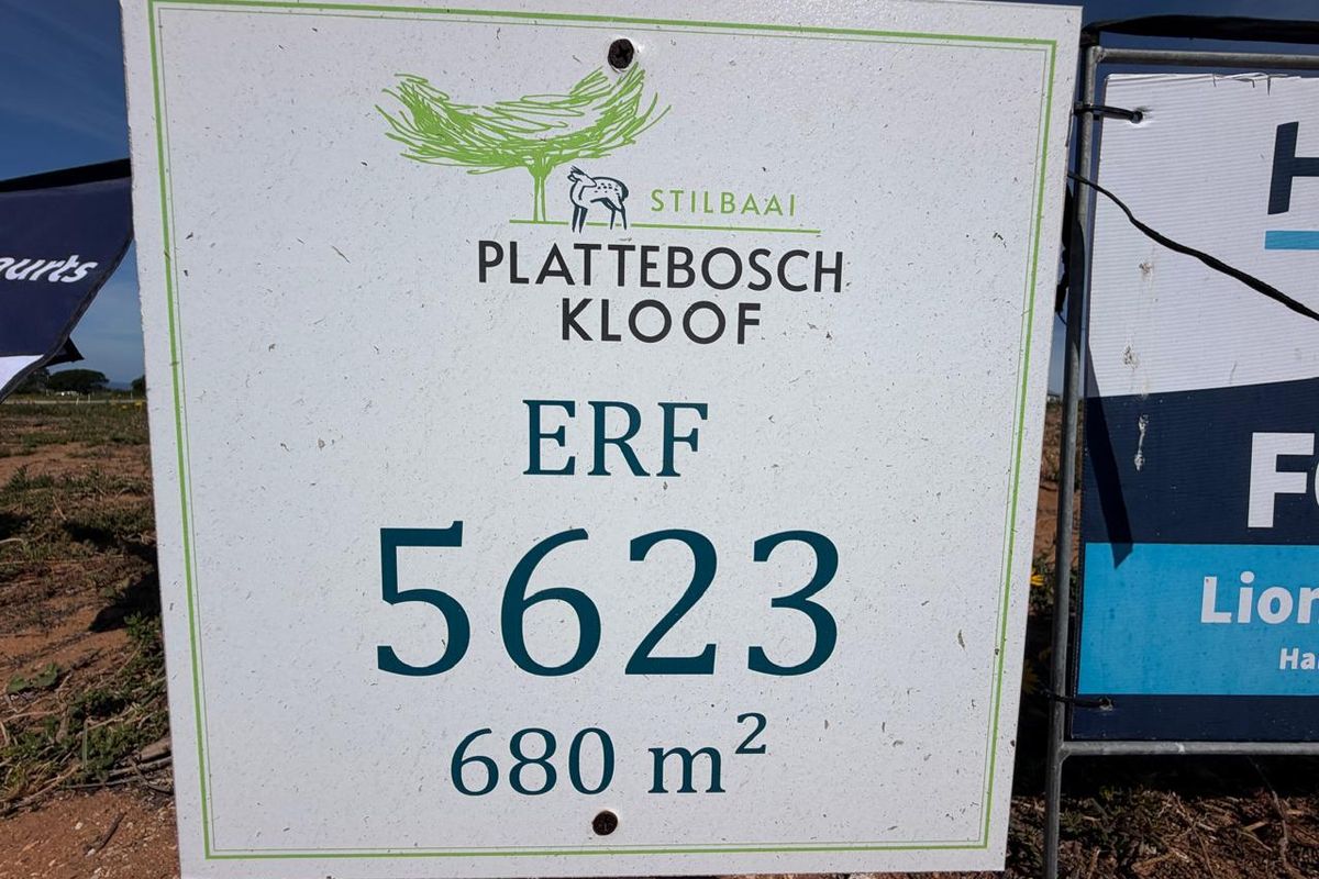 A real estate signage board displaying the erf number 5623 and land size of 680 square meters in Plattebosch Kloof, Stilbaai.