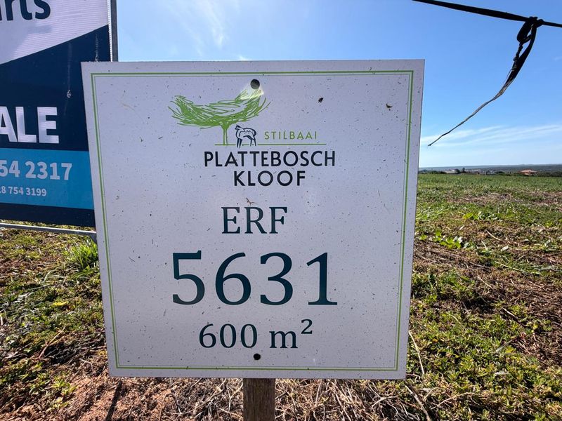 A close-up view of a real estate sign identifying Erf 5631, a 600 square meter vacant residential plot in Plattebosch Kloof, Stilbaai.