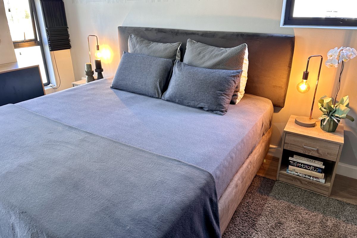 A well-maintained bedroom featuring modern roller blinds and neutral wall finishes, creating a comfortable and inviting sleeping space.