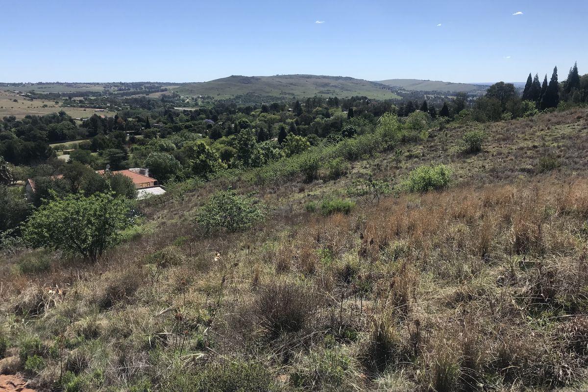 A scenic view overlooking the surrounding landscape and residential area from the elevated vacant land plot.