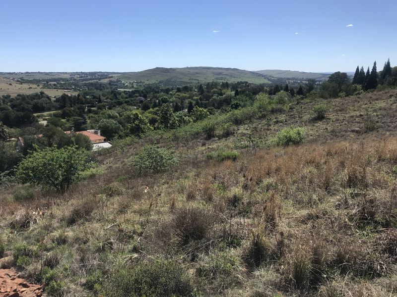 A scenic view overlooking the surrounding landscape and residential area from the elevated vacant land plot.