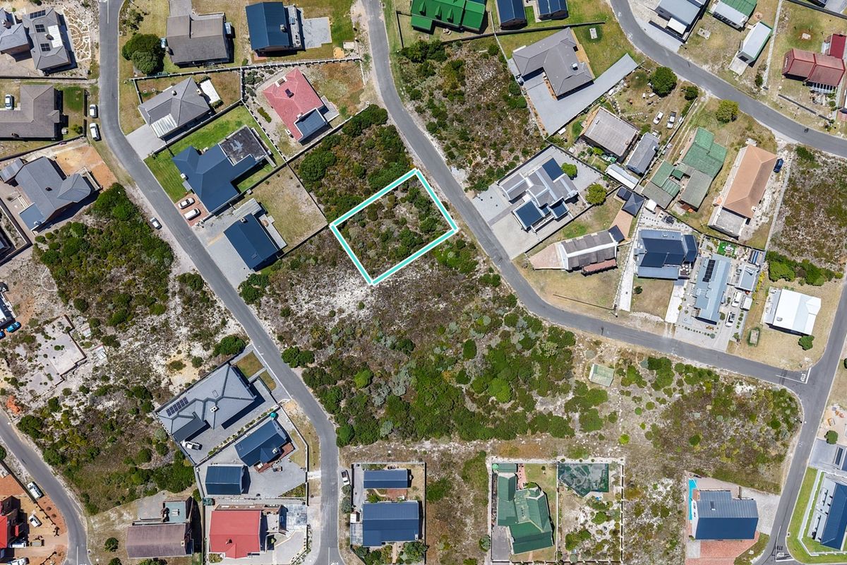 Aerial view of a vacant residential plot in a developed neighborhood, highlighting the property boundaries and surrounding residential infrastructure.