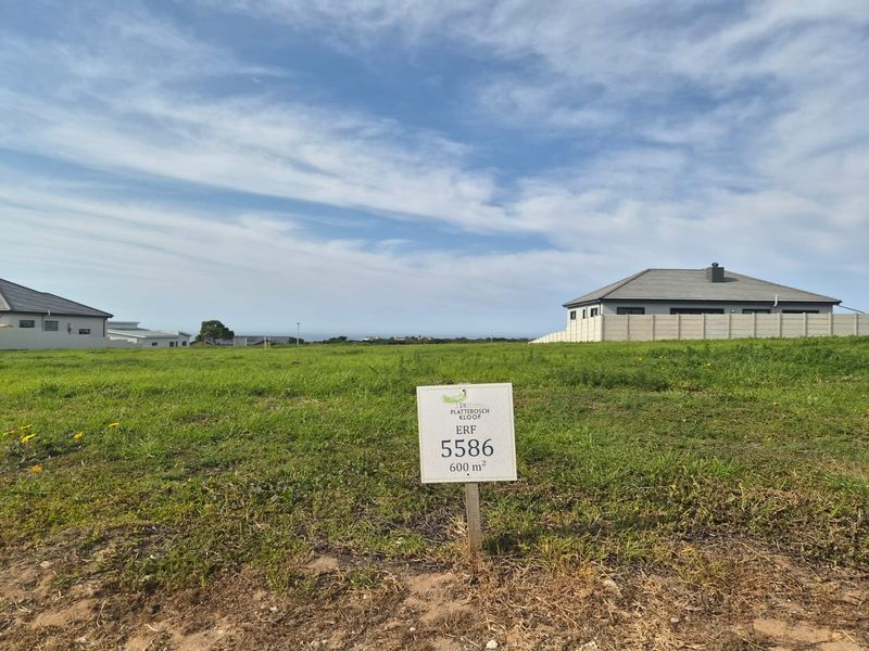 A vacant residential plot of 600 square meters, situated in a developed estate with surrounding homes and clear views.