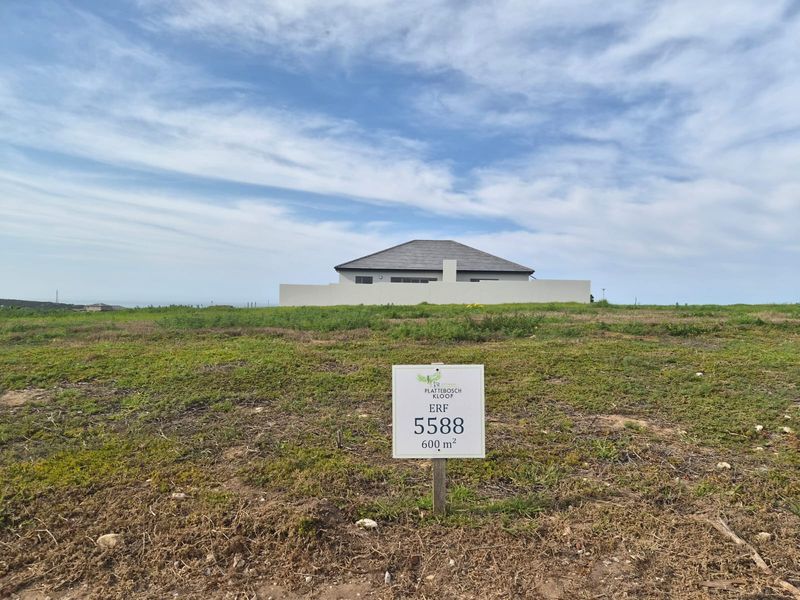 A vacant residential plot of 600 square meters, clearly marked with signage, offering a level building site in a developed estate.