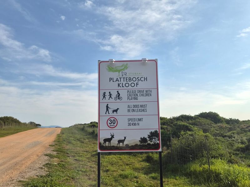 A view of the entrance road and estate signage for the Plattebosch Kloof residential area.
