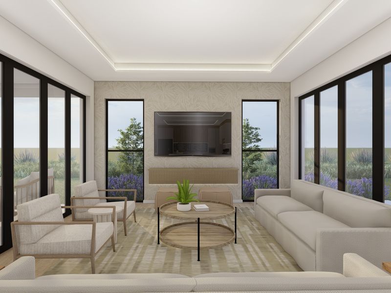 A modern, bright living room featuring large glass sliding doors, recessed ceiling lighting, and a built-in media console with elegant wallpaper.