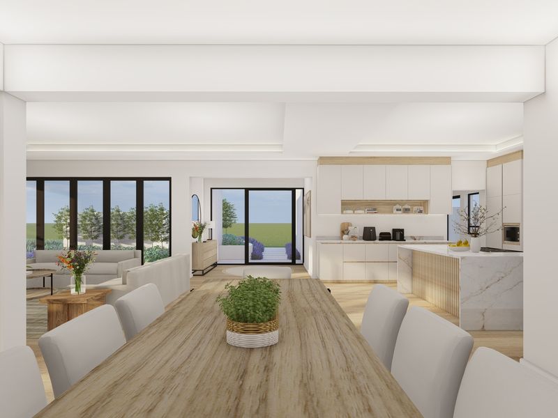 Spacious open-plan living area featuring a modern kitchen with stone island, integrated cabinetry, and seamless flow to the outdoor patio through large sliding doors.