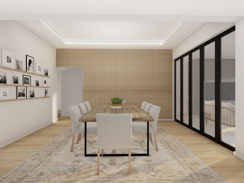 Modern dining room featuring timber slat wall paneling, recessed ceiling lighting, and large black-framed glass doors opening to an outdoor area.