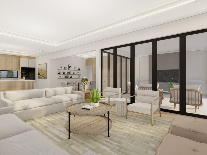 Modern open-plan living area featuring a contemporary kitchen, recessed lighting, and large black-framed sliding doors opening to an outdoor patio space.