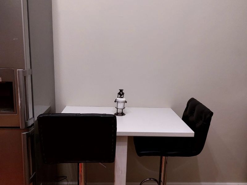 A compact kitchen corner featuring hardwood flooring and neutral wall finishes, suitable for a small breakfast nook or dining area.