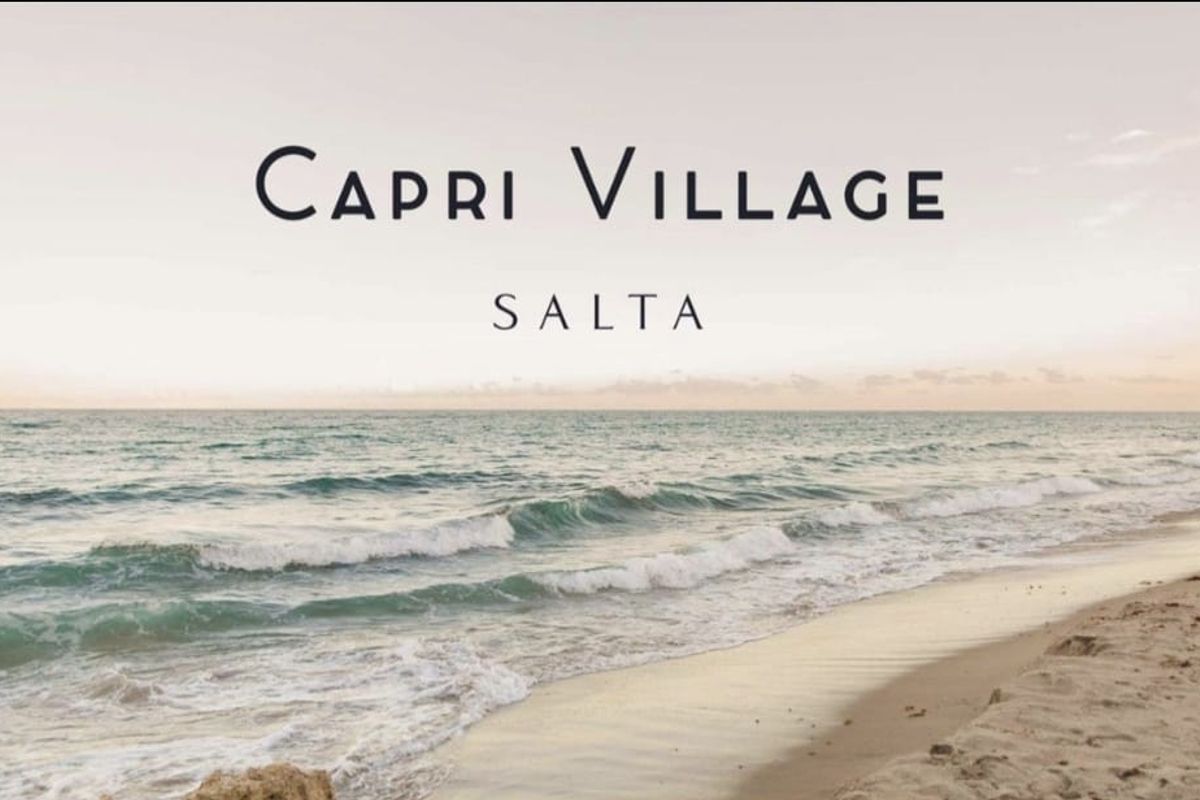 A scenic coastal view of the ocean and sandy beach, representing the location of the Capri Village Salta development.